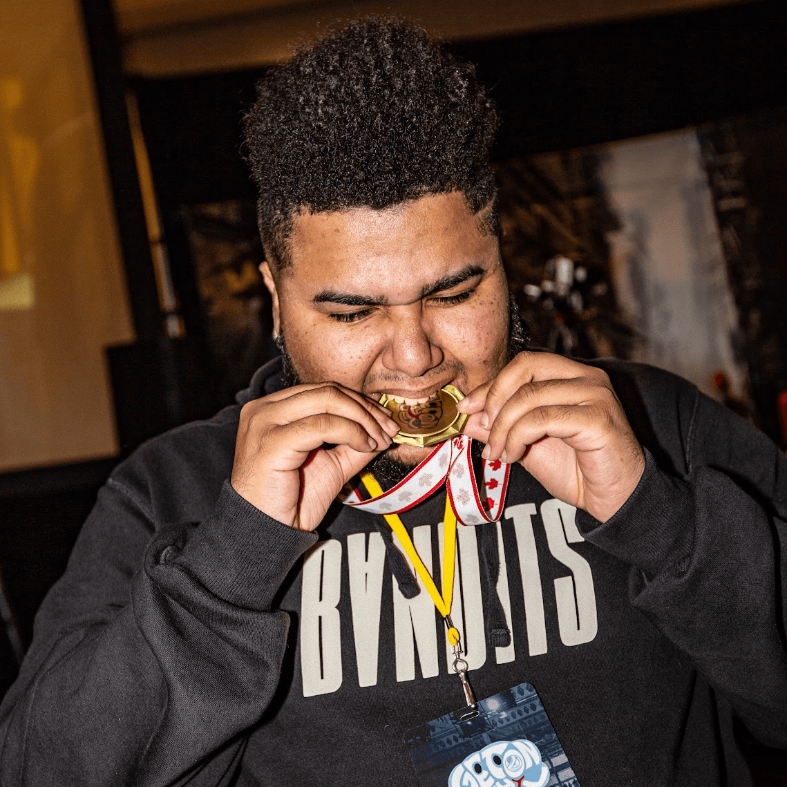 An event champion biting a medal