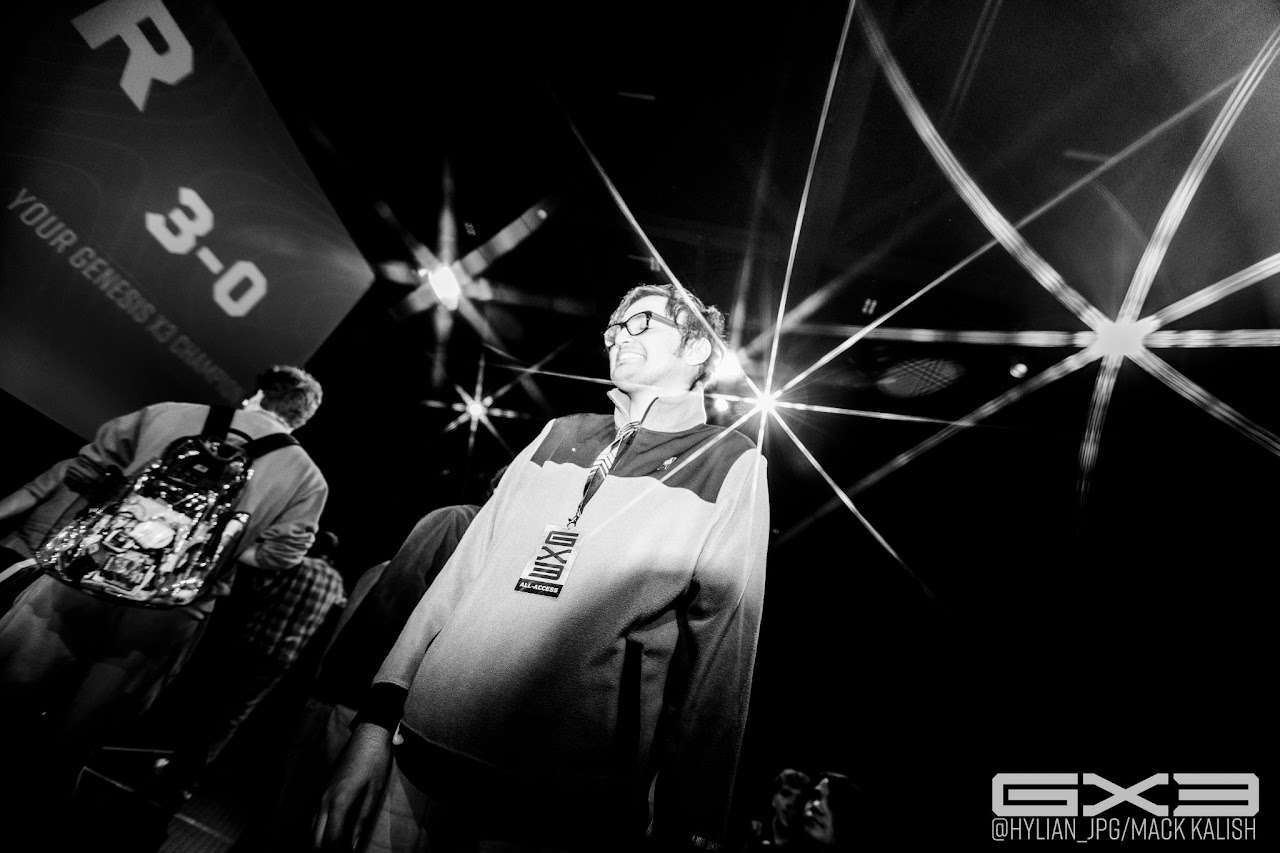An event producer looks toward the GENESIS X3 stage in black and white